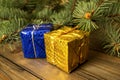 On the table there are two gifts - yellow and mini next to the fir tree. Christmas gifts. gifts for the New Year under the tree. Royalty Free Stock Photo