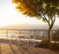 Table with three chairs with beuatiful view on Portland during sunrise