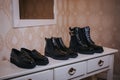 Table with three pairs of black shoes on it in the room Royalty Free Stock Photo