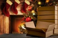 Christmas decorations and gift boxes, parcels with blurred christmas tree and fireplace background.