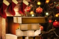 Christmas decorations and gift boxes, parcels with blurred christmas tree and fireplace background.