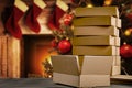 Christmas decorations and gift boxes, parcels with blurred christmas tree and fireplace background.