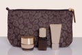 Table top on cosmetic background. Close-up of a beautiful brown cosmetic bag with various acial care products on a bright table Royalty Free Stock Photo