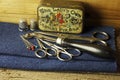 OLD PIN BOX WITH THIMBLES, SCISSORS, GLASSHEAD PINS AND TRACING WHEEL