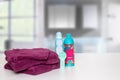 Table top on towels background. Closeup of fresh soft terry bath towels with soap and shampoo bottle on table over blurred Royalty Free Stock Photo