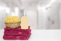 Table top on towels background. Closeup of fresh soft terry bath towels with soap bottle and basket with a natural sponge on table Royalty Free Stock Photo