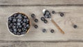 Table top view on bowl of blueberries, some of them spilled next Royalty Free Stock Photo