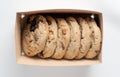 A table top view of box of cookies with six cookies inside Royalty Free Stock Photo