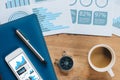 Table Top view of businessman  with compass, smart phone , pen ,notepad ,coffee cup and data report ,business and financial Royalty Free Stock Photo