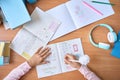 Table top view of child hands writing doing homework on math at home. Royalty Free Stock Photo