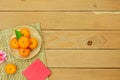 Table top view Lunar New Year & Chinese New Year vacation concept background.Flat lay orange in wood basket & pink cherry blossom Royalty Free Stock Photo