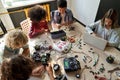 Group of multiracial schoolkids at stem class building robot. Table top view. Royalty Free Stock Photo