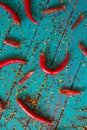 Table top view ovwe red chilli and seeds on blue background Royalty Free Stock Photo