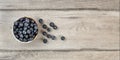 Table top view - small bowl with blueberries, some of them spill Royalty Free Stock Photo