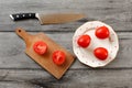 Table top view on three tomatoes on white porcelain plate with r Royalty Free Stock Photo