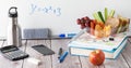 Table top view of a variety of school supplies with a lunch kit and water bottle, against a whiteboard. Royalty Free Stock Photo