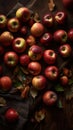 a table topped with lots of red and green apples next to leaves and a cloth on top of a wooden table cloth covered in leaves