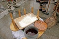 Table with traditional Bulgarian food pitka bread, kneading dough and copper menche ot buklitsa