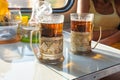 On the table in the train compartment are glasses with tea in metal cup holders Royalty Free Stock Photo