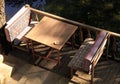 Table and two benches with coffee cup, close to water Royalty Free Stock Photo