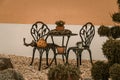 Table with two chairs and autumnal decoration in a mediterranean garden Royalty Free Stock Photo