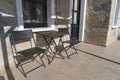 Table and two chairs in the courtyard in front of the entrance to the house Royalty Free Stock Photo