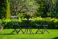 Chic Wrought Iron Patio Set in a Lush Garden Royalty Free Stock Photo