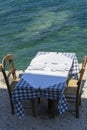 Table and two chairs of street greece restaurant on Crete in the sunny day Royalty Free Stock Photo