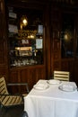 Table With Two Chairs and White Table Cloth outside the restaurant Botin in Madrid, Spain