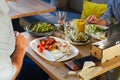 At the table, two men eat dinner, eat a steak, with a salad on a white plate, with a fork and knife in their hands. Royalty Free Stock Photo