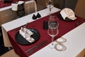 Table for two persons in a restaurant decorated with a red tablecloth and black plates Royalty Free Stock Photo