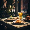 a table with two plates of food and a glass of orange juice