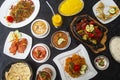 Table with typical Indian dishes, Biryani, chicken curry, tandoori, tikka masala, korma, rice pilau Royalty Free Stock Photo