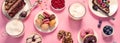 Table with various cookies, donuts, cakes, coffee cups on pink background Royalty Free Stock Photo