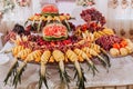 table with various fruit decorations. Watermelon carving, pineapple slices Royalty Free Stock Photo