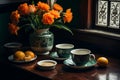 a table with a vase of flowers and two cups and saucers