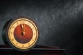 Table vintage analog round clock with copy space. Five minutes to twelve Royalty Free Stock Photo