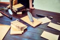 Table with vintage writing utensils. Books, paper and feather for writing in ink