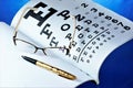 Table of vision testing, glasses, doctor`s log. Glasses - optical device for vision correction. Medical table with symbols for th Royalty Free Stock Photo