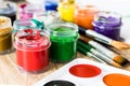 On the table are watercolor paints, brushes and gouache paints. Set for drawing, creativity and hobbies Royalty Free Stock Photo