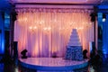 Table with a wedding cake, candles and flowers. Photo-wall, wedding decoration space or place from white and silver Royalty Free Stock Photo