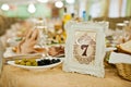 Table of wedding reception with delicious food and number 7. Royalty Free Stock Photo