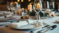 Table with a white tablecloth and a fancy dinner setting with a wine glass Royalty Free Stock Photo