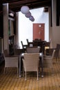 Table and wicker chairs in a brown cafe