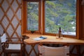 Table between the window of the luxury yurt in the forest
