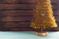 Table of wood and xmas tree gold tinsel, Royalty Free Stock Photo