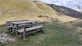 Table with wooden benches for a quiet picnic in the mountains Royalty Free Stock Photo