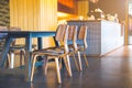 Table and wooden chairs in a modern coffee shop. Royalty Free Stock Photo