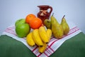Tablecloth with pears, bananas, oranges and fresh green apples Royalty Free Stock Photo