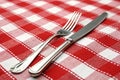 Tableknife and fork on red checked tablecloth Royalty Free Stock Photo